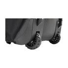 Close-up of a black suitcase with wheels on a white background