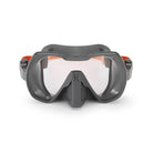A grey diving mask with a single lens and a soft silicone skirt, designed for wide field of vision and comfortable fit.